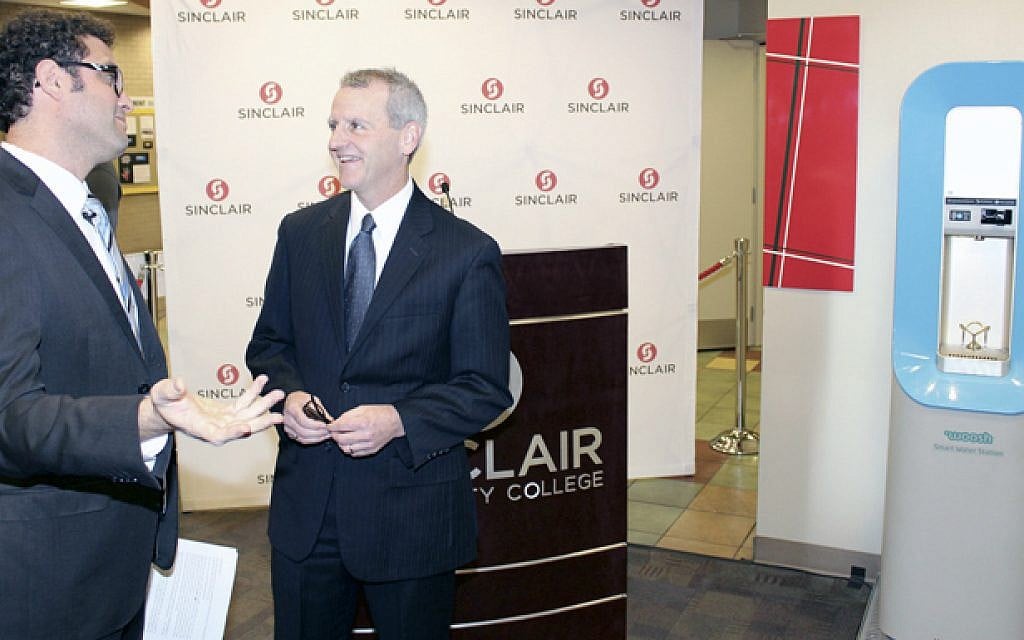 Woosh co-founder and CEO Itay Tayas-Zamir (L) with Montgomery County Commissioner Dan Foley at the launch of Woosh Water Stations at Sinclair Community College in Dayton on February 1, 2016. (Marshall Weiss, The Dayton Jewish Observer) Woosh co-founder and CEO Itay Tayas-Zamir (L) with Montgomery County Commissioner Dan Foley at the launch of Woosh Water Stations at Sinclair Community College in Dayton on February 1, 2016. (Marshall Weiss, The Dayton Jewish Observer)