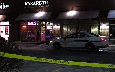 Police talk inside the Columbus, Ohio, restaurant where they say a man attacked several people with a machete on Thursday, February 11, 2016. (AP/Kantele Franko)