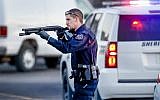 Police go through the parking lot of Excel Industries in Hesston, Kansas, where a gunman killed at least four people and injured many more, February 25, 2016. (Fernando Salazar/The Wichita Eagle via AP)