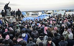 Syrians fleeing the embattled northern city of Aleppo wait near a crossing into Turkey in Bab-Al Salama, near the northern city of Azaz, on February 5, 2016. (AFP/Bulent Kilic)