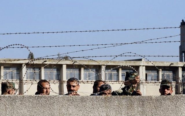 Members of the Syrian government forces look on as hundreds of civilians and Syrian rebel forces begin evacuating the last opposition-held district of Waer in the central city of Homs, under a deal with the Syrian regime, December 9, 2015. (AFP/Louai Beshara) Members of the Syrian government forces look on as hundreds of civilians and Syrian rebel forces begin evacuating the last opposition-held district of Waer in the central city of Homs, under a deal with the Syrian regime, December 9, 2015. (AFP/Louai Beshara)
