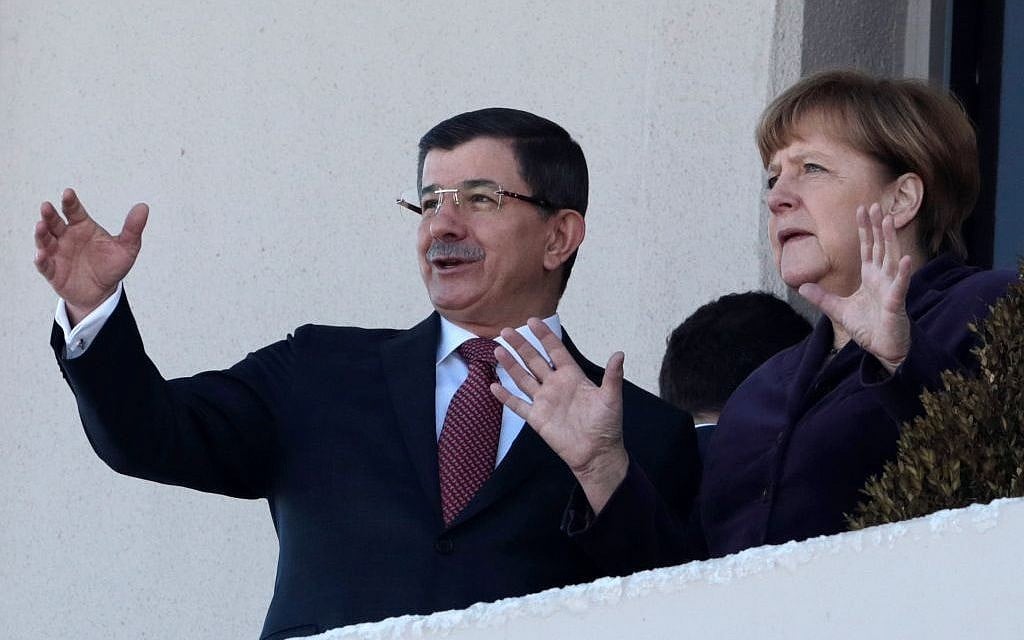 German Chancellor Angela Merkel, right, and Turkish Prime Minister Ahmet Davutoglu speak as they look toward the city center after a welcome ceremony in Ankara, Turkey, Monday, February 8, 2016. (AP/Burhan Ozbilici)