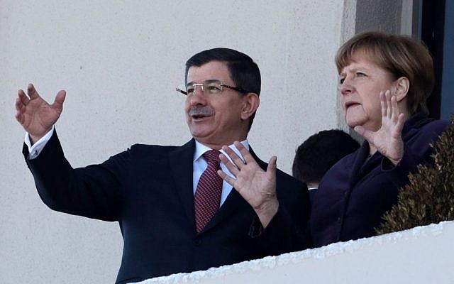 German Chancellor Angela Merkel, right, and Turkish Prime Minister Ahmet Davutoglu speak as they look toward the city center after a welcome ceremony in Ankara, Turkey, Monday, February 8, 2016. (AP/Burhan Ozbilici)