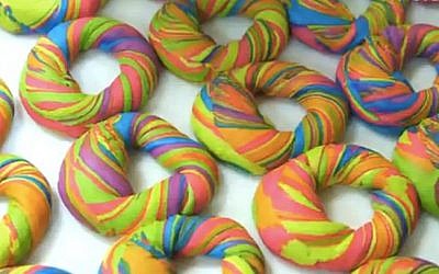 These rainbow bagels are served at Williamsburg Brooklyn's The Bagel Shop and are recommended with funfetti cream cheese. (YouTube)