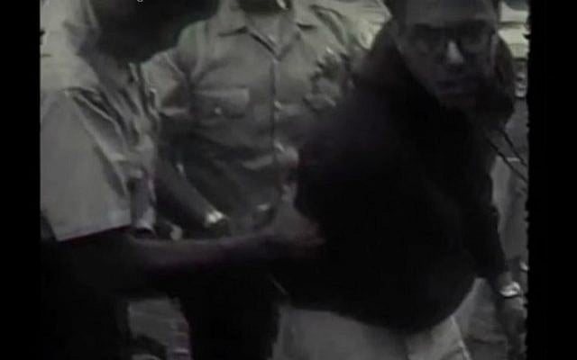 A 1963 photo of a 21-year-old Bernie Sanders being arrested at a protest for desegregation in Chicago public schools. (YouTube screen capture of Kartemquin Films footage) A 1963 photo of a 21-year-old Bernie Sanders being arrested at a protest for desegregation in Chicago public schools. (YouTube screen capture of Kartemquin Films footage)