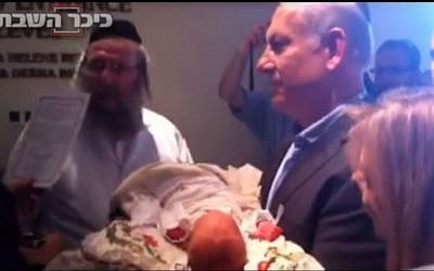 Benjamin Netanyahu at the circumcision ceremony of his grandson in 2011. (screen capture: YouTube/Kikar Hashabat)