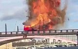 An iconic London double decker bus exploding on a bridge during the filming of the Jackie Chan and Pierce Brosnan action movie "The Foreigner." (Screen capture/Twitter)