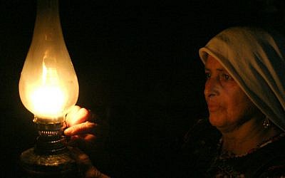 A Palestinian Bedouin women from the Ghwain tribe lights a candle in her home south of Hebron in this May 29, 2008 illustrative photo. (Najeh Hashlamoun /Flash90)