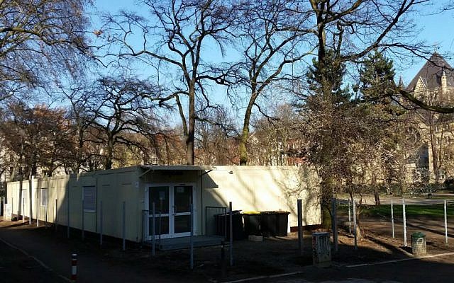 Teenage refugees live in these containers, located in a public park in Cologne, Germany. In the background, the city's Roonstrasse synagogue (Raphael Ahren/TOI) Teenage refugees live in these containers, located in a public park in Cologne, Germany. In the background, the city's Roonstrasse synagogue (Raphael Ahren/TOI)