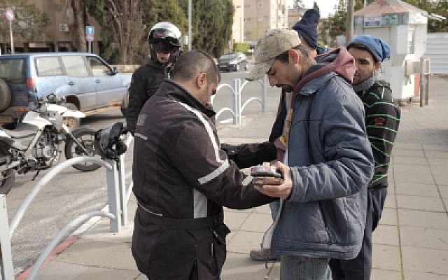 Israeli security forces frisk Arab Israelis near the Central Bus Station in Herzliya, January 5, 2016, as the city was on high alert. (Tomer Neuberg/Flash90 Israeli security forces frisk Arab Israelis near the Central Bus Station in Herzliya, January 5, 2016, as the city was on high alert. (Tomer Neuberg/Flash90