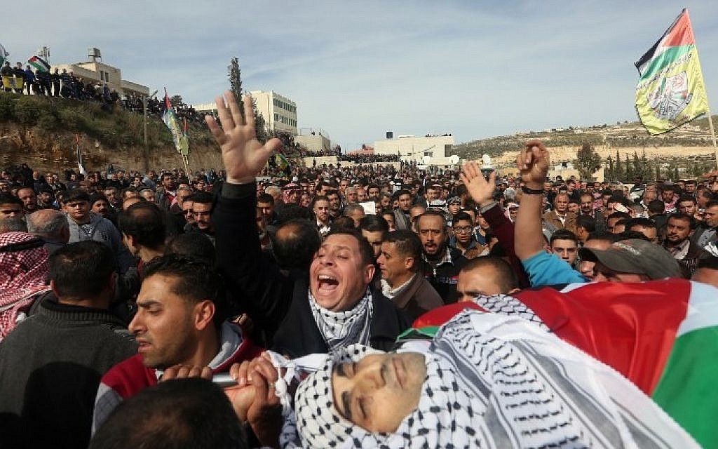 Palestinian mourners carry the body of Amjad Abu Omar Sakari, who was shot dead while carrying out an attack on Israeli soldiers near the Beit El settlement, during his funeral in the village of Jamain south of Nablus, February 1, 2016. (AFP/Jaafar Ashtiyeh)