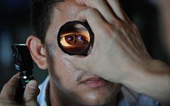 File - an optometrist fits a patient with glasses (PIxabay)