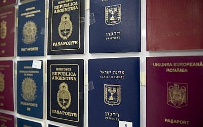 A presser, counterfeit passport printing plates and fake passports are displayed at the immigration bureau in Bangkok on February 10, 2016. (NICOLAS ASFOURI / AFP)