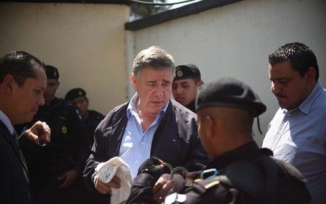 Hugo Roitman, center, is escorted to court in the Villa Nueva municipality, 25 kilometers south of Guatemala City, on February 23, 2016. (AFP/Johan Ordonez) Hugo Roitman, center, is escorted to court in the Villa Nueva municipality, 25 kilometers south of Guatemala City, on February 23, 2016. (AFP/Johan Ordonez)