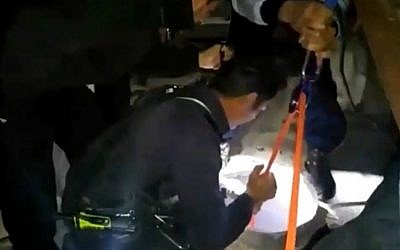 Beit Shemesh firefighters rescue a 17-year-old would-be thief trapped in a store's chimney during a botched overnight robbery, February 4, 2016. (Screen capture/Beit Shemesh Fire and Rescue Services)