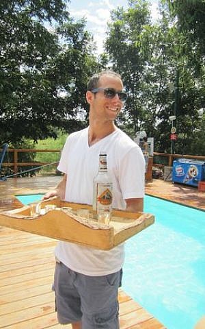 Yuval Olshinski serving drinks to guests at his family's tzimmer in Beit Hillel (Courtesy Trip Advisor)