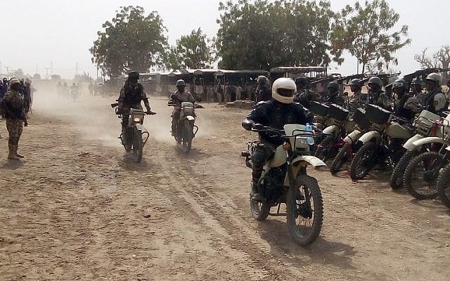 Soldiers of the 25 task force brigade of the Nigerian army ride new motorcycles to provide security on reopened highways, in northeast Nigerian state of Borno, on February 27, 2016. (AFP / STRINGER)