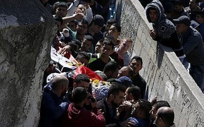 Mourners attend the funeral of a Palestinian man killed during clashes with Israeli security forces at the Qalandiya refugee camp on March 1, 2016 in the Israeli-occupied West Bank. (AFP / ABBAS MOMANI)