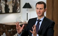 File: Syrian President Bashar Assad listening to a question during an interview with AFP in the capital Damascus, February 11, 2016. (AFP/JOSEPH EID)