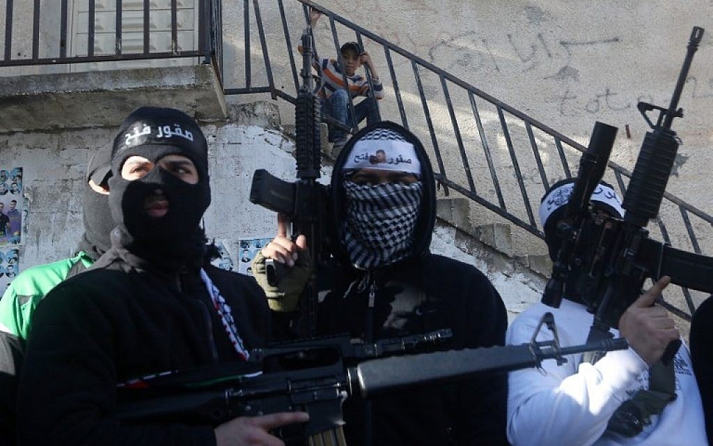Illustrative: Palestinian members of Al-Aqsa Martyrs' Brigades, the armed wing of the Fatah movement, raise their weapons during a rally to support Palestinian Authority President Mahmoud Abbas and his government on March 1, 2016, in the West Bank Balata refugee camp near Nablus (AFP / JAAFAR ASHTIYEH)