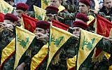 Members of Lebanon's Shiite Hezbollah hold their flags during the funeral of a Hezbollah fighter, who was killed while fighting alongside Syrian government forces in Syria, March 1, 2016. (AFP/Mahmoud Zayyat)