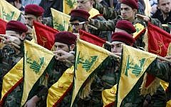 Members of Lebanon's Shiite Hezbollah hold their flags during the funeral of a Hezbollah fighter, who was killed while fighting alongside Syrian government forces in Syria, March 1, 2016. (AFP/Mahmoud Zayyat)