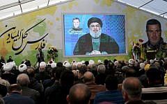 Supporters of Lebanon's Shiite Hezbollah group watch a televised speech by leader Hassan Nasrallah in the southern town of Insar, Lebanon, March 6, 2016. (AFP/Mahmoud Zayyat)