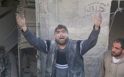 A Syrian man reacts as rescue workers try to pull a victim out from under the rubble of a building following a reported air strike on the rebel-held neighbourhood of Salhin in the northern city of Aleppo on March 11, 2016. (AFP/THAER MOHAMMED) A Syrian man reacts as rescue workers try to pull a victim out from under the rubble of a building following a reported air strike on the rebel-held neighbourhood of Salhin in the northern city of Aleppo on March 11, 2016. (AFP/THAER MOHAMMED)