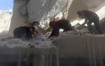 Syrian rescue workers and residents try to pull a man out from under the rubble of a building following a reported air strike on the rebel-held neighborhood of Salhin in the northern city of Aleppo on March 11, 2016. (AFP/THAER MOHAMMED) Syrian rescue workers and residents try to pull a man out from under the rubble of a building following a reported air strike on the rebel-held neighborhood of Salhin in the northern city of Aleppo on March 11, 2016. (AFP/THAER MOHAMMED)