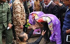 Iraqi men prepare carry the wrapped body of three-year-old Fatima Wais, who was killed following a chemical attack by the Islamic State group against the town of Taza, south of Kirkuk, during her funeral on March 11, 2016. (AFP/Marwan IBRAHIM)