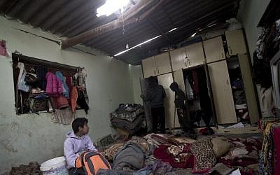 Palestinian children inspect a bedroom of the damaged Khussa family home after an Israeli strike on Hamas bases in Beit Lahiya, northern Gaza strip on March 12, 2016. (AFP/MAHMUD HAMS)