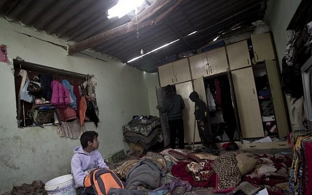 Palestinian children inspect a bedroom of the damaged Khussa family home after an Israeli strike on Hamas bases in Beit Lahiya, northern Gaza strip on March 12, 2016. (AFP/MAHMUD HAMS) Palestinian children inspect a bedroom of the damaged Khussa family home after an Israeli strike on Hamas bases in Beit Lahiya, northern Gaza strip on March 12, 2016. (AFP/MAHMUD HAMS)