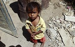 A Yemeni child stands outside the family house which was destroyed several months ago in an air-strike by the Saudi-led coalition at a slum in the capital Sanaa, on March 12, 2016. (AFP/Mohammed Huwais)