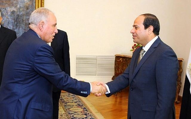Egyptian President Abdel-Fattah el-Sissi, right, shaking hands with Ahmed al-Zind during his swearing-in ceremony as justice minister in Cairo, May 20, 2015. (AFP/Egyptian Presidency/HO) Egyptian President Abdel-Fattah el-Sissi, right, shaking hands with Ahmed al-Zind during his swearing-in ceremony as justice minister in Cairo, May 20, 2015. (AFP/Egyptian Presidency/HO)