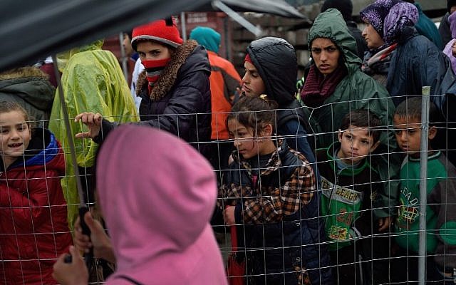 Migrants queue for free food at a makeshift camp at the Greek-Macedonian border, near the Greek village of Idomeni on March 15, 2016, where thousands of refugees and migrants are stranded by the Balkan border blockade.(AFP / DANIEL MIHAILESCU)
