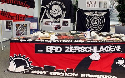 A photo taken on March 2, 2012 shows neo-nazi flags, masks, weapons and a giant banner reading 'BRD zerschlagen! WWT Sektion Hamburg' (Disintegrate Federal Republic of Germany! WWT Section Hamburg) displayed during a press conference in Hamburg, northern Germany.  
(AFP / dpa / Malte Christians)