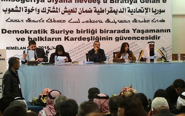 Aldar Khalil , center, from the Movement for a Democtratic Society, and Sheikh Hamad Sheikh Shihadeh, right, the Naim clan chief in northern Syria, speak during a meeting of more than 150 delegates from Kurdish, Arab, Assyrian and other parties in the town of Rmeilan, in Syria's northeastern Hasakeh province, on March 16, 2016. (AFP / DELIL SOULEIMAN)
