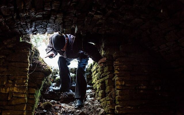 Jozef Jarosz creeps on March 16, 2016 into an underground hideout in Stankowa, Poland, where he and his family helped Anna Grygiel and 13 other Jews to survive the Holocaust and WWII. (AFP / WOJTEK RADWANSKI) Jozef Jarosz creeps on March 16, 2016 into an underground hideout in Stankowa, Poland, where he and his family helped Anna Grygiel and 13 other Jews to survive the Holocaust and WWII. (AFP / WOJTEK RADWANSKI)