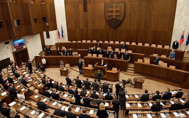 Deputies stand after Slovak Prime Minister-elect and leftist Smer-Social Democracy party leader Robert Fico took the oath of office on the Slovak Constitution, March 23, 2016. (AFP/SAMUEL KUBANI)