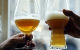Illustrative photo of people toasting with glasses of beer on March 20, 2016. (AFP / FRANCOIS GUILLOT)