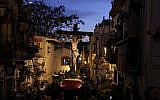 An effigy of Jesus Christ on the cross is carried during the 'Cristo de la Fe,' popularly known as the gypsy Christ, parade during a Holy Week procession on April 1, 2015, in Alicante. (AFP / JOSE JORDAN)