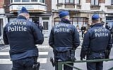 Three police officers stand guard at the Meiser neighborhood in Schaarbeek on March 25, 2016 during an anti-terrorist operation searching for suspects of March 22 terrorist attacks in Brussels. (AFP/Belga/Laurie Dieffembacq)