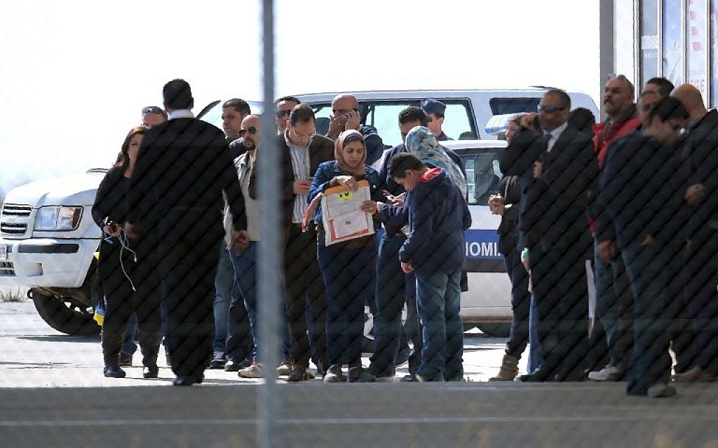 Passengers of an EgyptAir Airbus A-320 which was hijacked and diverted to Cyprus stand at Larnaca airport after disembarking the plane on March 29, 2016. (AFP/George Michael)