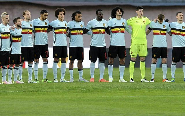 Belgian players embrace on the pitch and observe a minute of silence to honor the Brussels attacks victims before the friendly football match between Portugal and Belgium at Magalhaes Pessoa stadium in Leiria, Portugal on March 29, 2016. (Francisco Leong/AFP)
