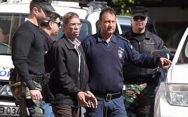 Seif al-Din Mohamed Mostafa, center, an Egyptian man who hijacked an EgyptAir passenger plane the previous day and forced it to divert to Cyprus, wears handcuffs as he leaves the court in Larnaca escorted by Cypriot police, March 30, 2016. (AFP/GEORGE MICHAEL) Seif al-Din Mohamed Mostafa, center, an Egyptian man who hijacked an EgyptAir passenger plane the previous day and forced it to divert to Cyprus, wears handcuffs as he leaves the court in Larnaca escorted by Cypriot police, March 30, 2016. (AFP/GEORGE MICHAEL)