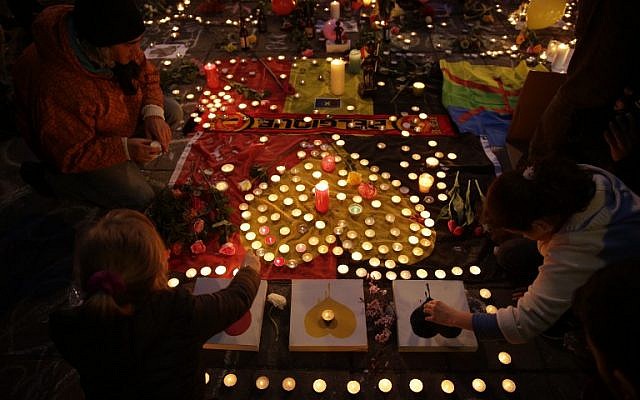 People light candles in tribute to victims at a makeshift memorial in front of the stock exchange at the Place de la Bourse (Beursplein) in Brussels on March 22, 2016, following triple bomb attacks in the Belgian capital that killed about 35 people and left more than 200 people wounded.(AFP PHOTO / KENZO TRIBOUILLARD) People light candles in tribute to victims at a makeshift memorial in front of the stock exchange at the Place de la Bourse (Beursplein) in Brussels on March 22, 2016, following triple bomb attacks in the Belgian capital that killed about 35 people and left more than 200 people wounded.(AFP PHOTO / KENZO TRIBOUILLARD)