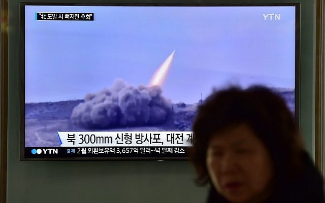 File: A woman walks past a public television screen showing file footage of a North Korean missile, at a railway station in Seoul, March 4, 2016. (AFP/JUNG YEON-JE) File: A woman walks past a public television screen showing file footage of a North Korean missile, at a railway station in Seoul, March 4, 2016. (AFP/JUNG YEON-JE)