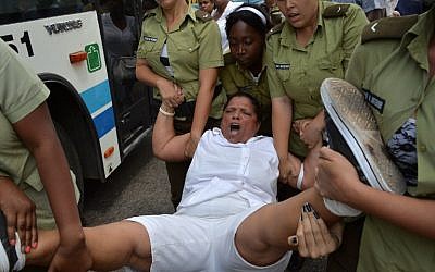 A member of the Ladies in White Human Rights organization is arrested during a march on March 20, 2016 in Havana, hours before the arrival of US President Barack Obama. (AFP PHOTO/ADALBERTO ROQUE)
