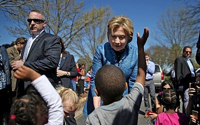Hillary Clinton greets children outside of a polling station at Southeast Raleigh Magnet High School in Raleigh, North Carolina, March 15, 2016. (Justin Sullivan/Getty Images/AFP)
