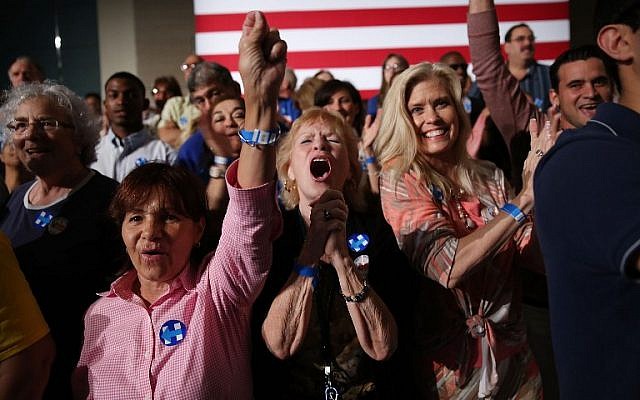 People react to early returns showing that Democratic presidential candidate former Secretary of State Hillary Clinton is leading her rival in the vote count for the state of Florida during her Primary Night Event at the Palm Beach County Convention Center on March 15, 2016 in West Palm Beach, Florida. (Joe Raedle/Getty Images/AFP)
